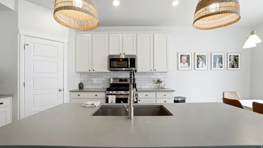 Expansive kitchen island featuring an undermount sink with a gooseneck faucet