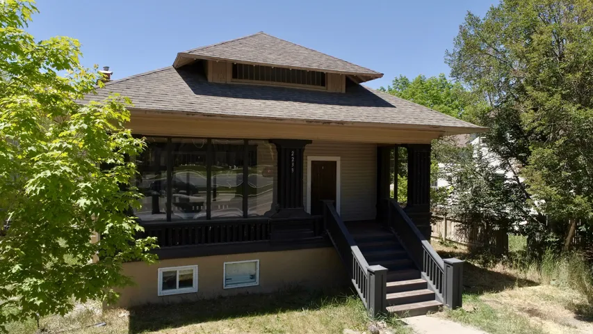 Craftsman-style exterior featuring a covered porch, multi-pane windows, a prominent dormer, and a neutral siding finish