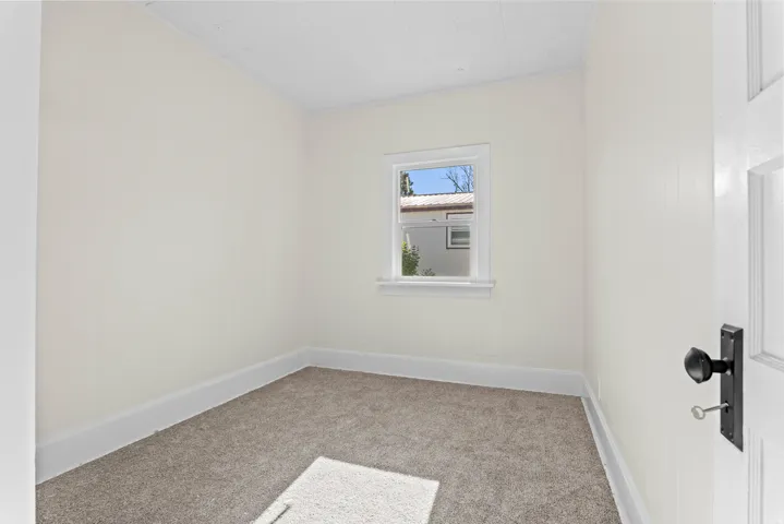 Neutral wall finishes, textured carpeting, and white baseboards