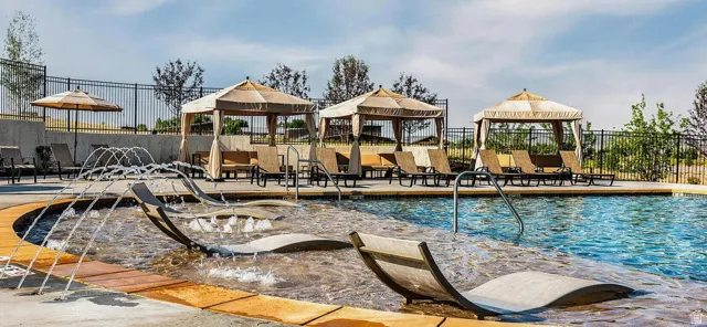 Resort-style pool with integrated loungers and water features