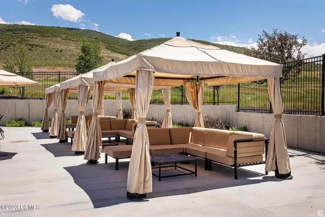 Outdoor patio featuring multiple covered cabanas with integrated seating