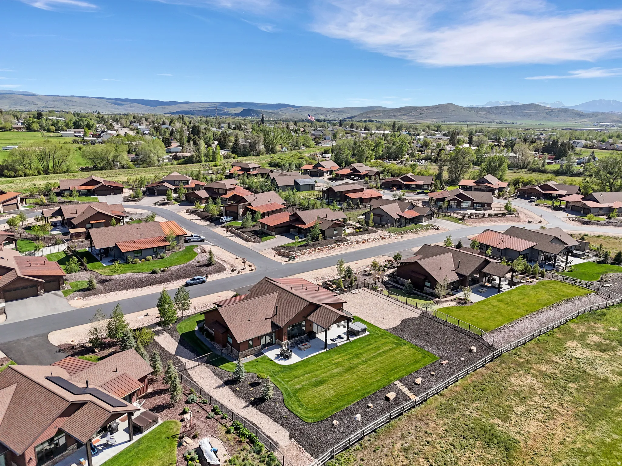 Aerial perspective of a neighborhood featuring multiple single-family residences with brown roofs
