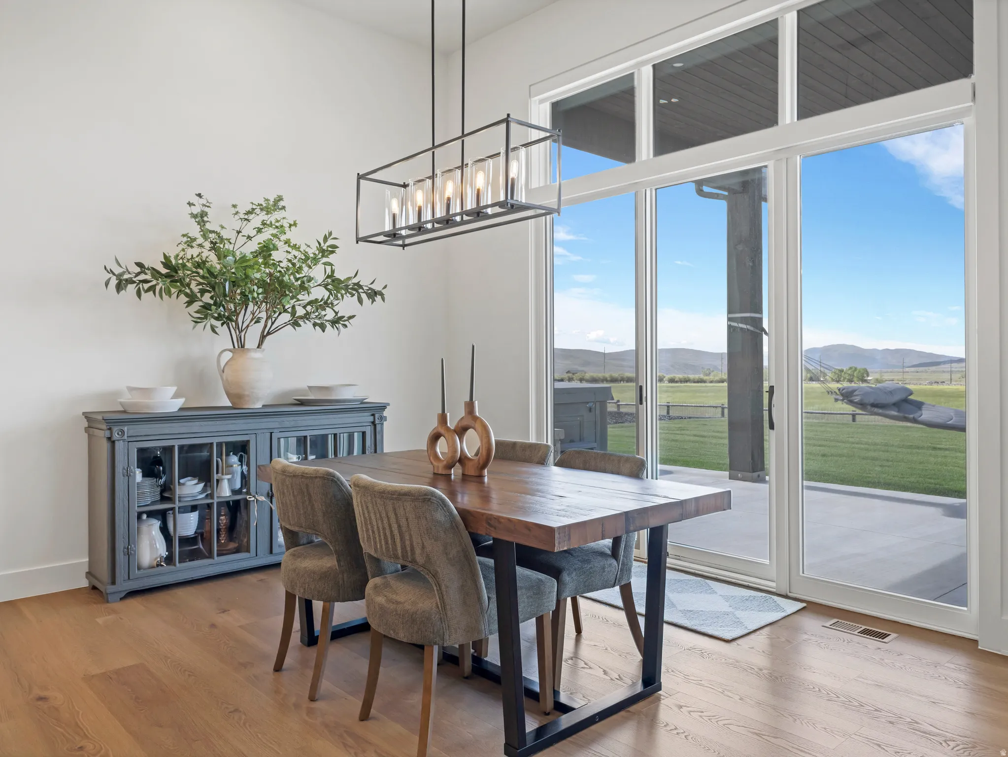 Expansive glass sliding doors open to outdoor space