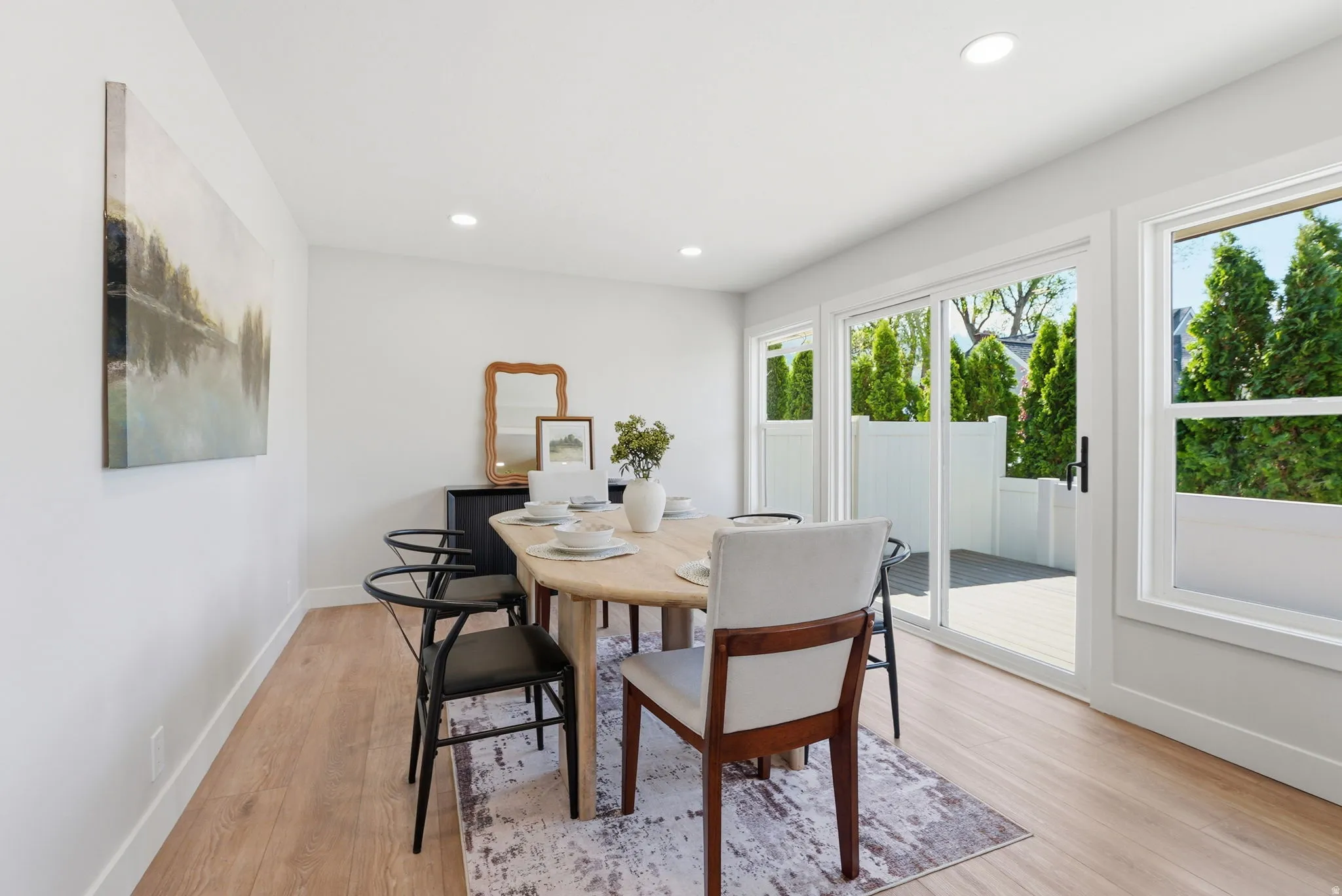 Dining area featuring wood-finish flooring, recessed lighting, and white baseboards