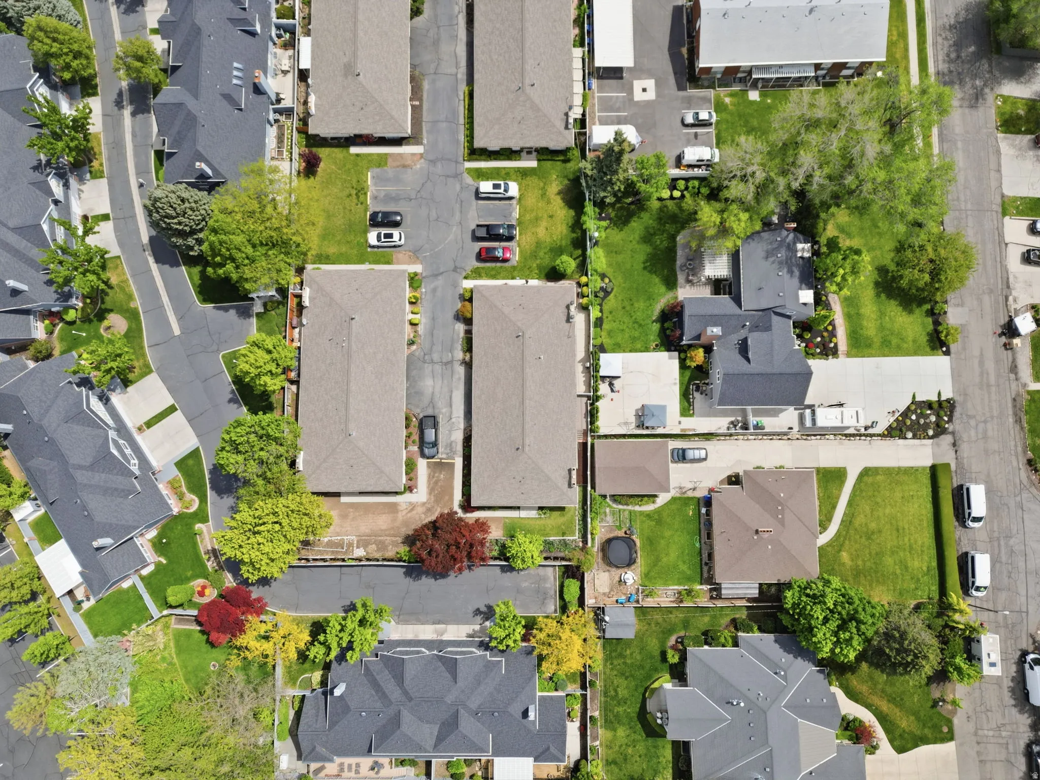 Aerial perspective showcasing multiple residential structures with pitched roofs