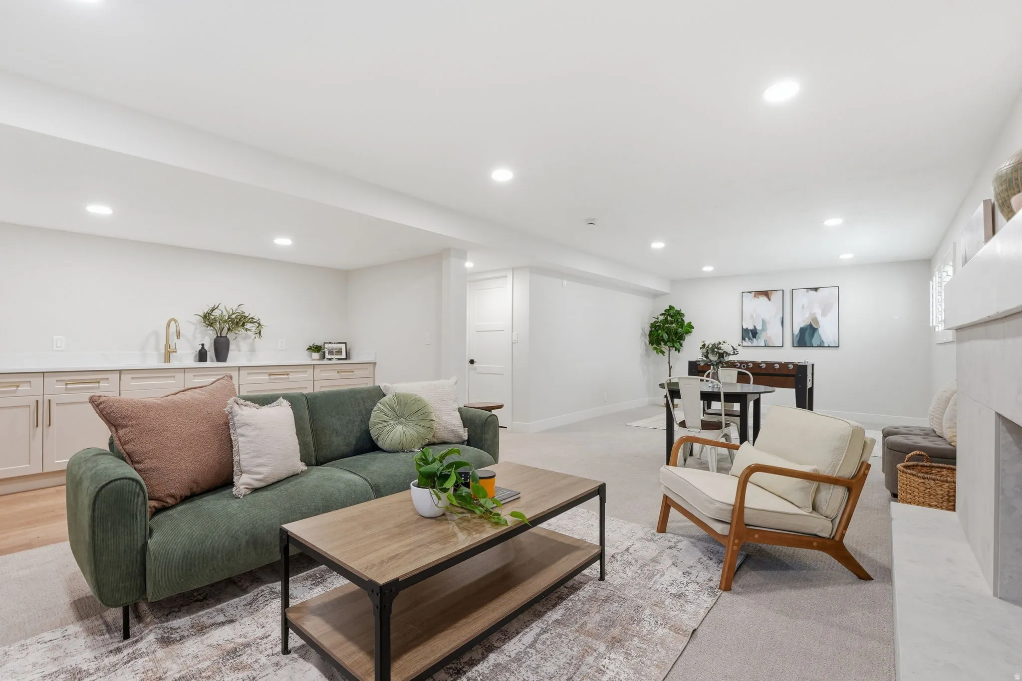 Brightly lit lower-level living area with recessed lighting