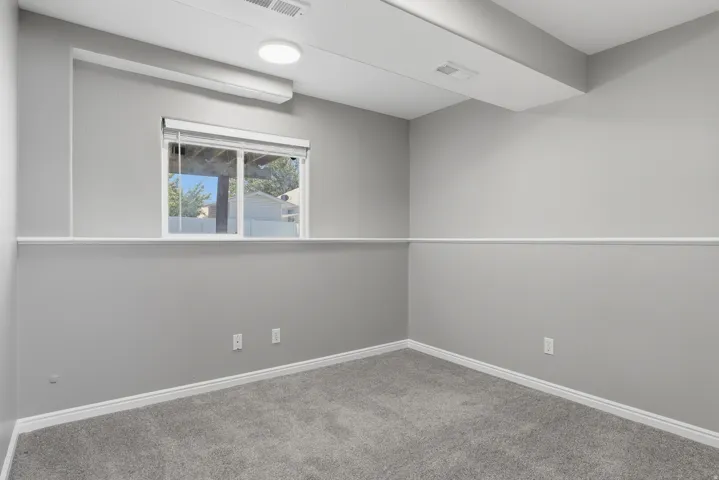 Interior room with grey carpet flooring and light grey walls