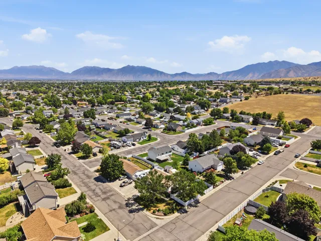 Aerial panorama of a residential neighborhood with mountain backdrop