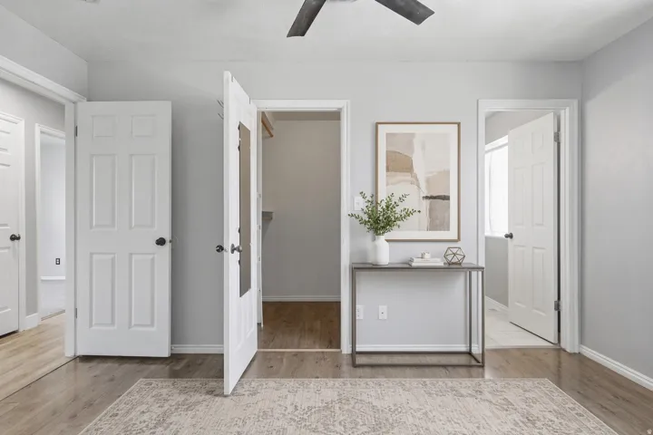 Wood-finish flooring throughout, with light gray painted walls