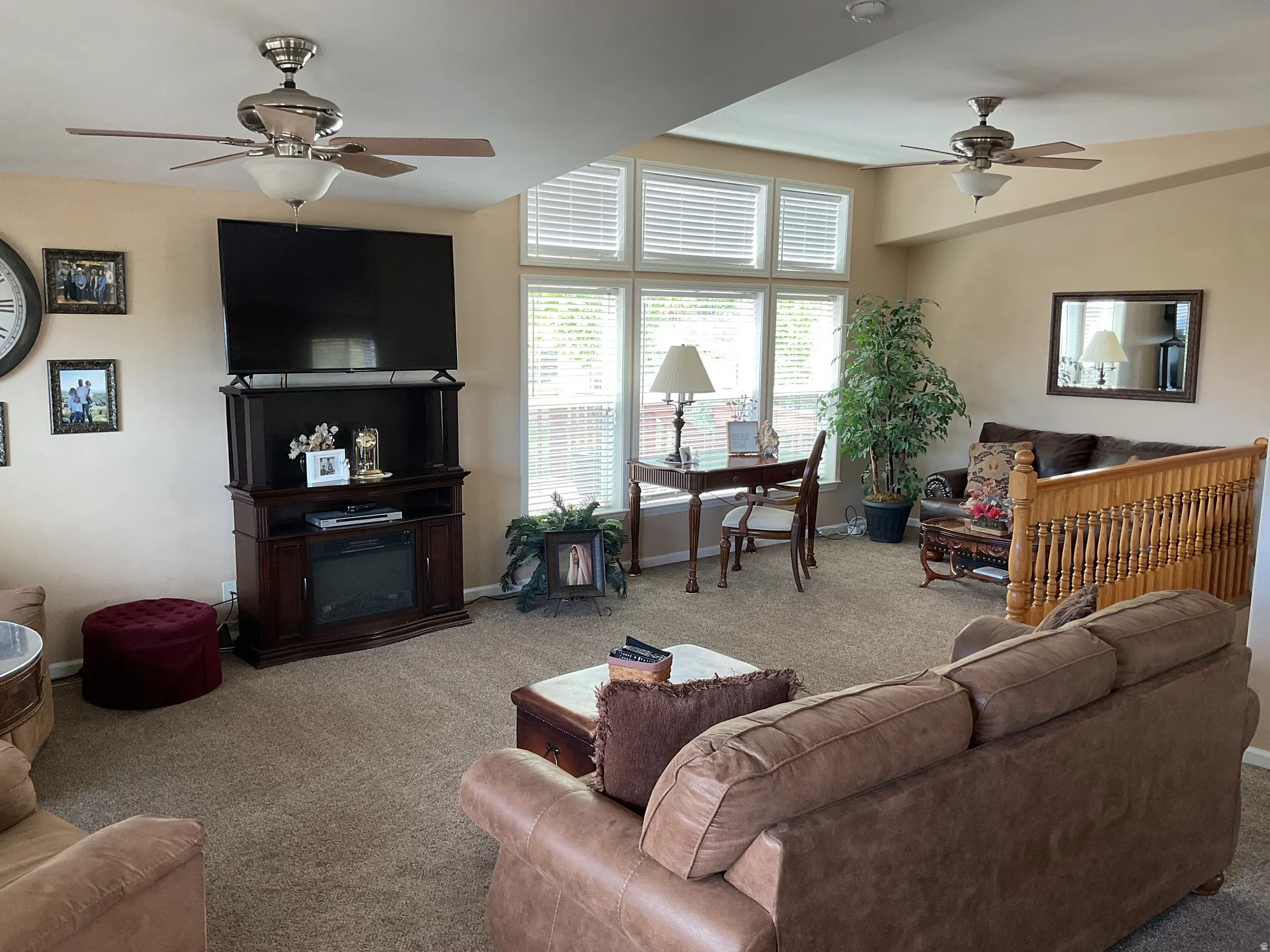 Expansive living area with neutral carpeting and warm-toned walls