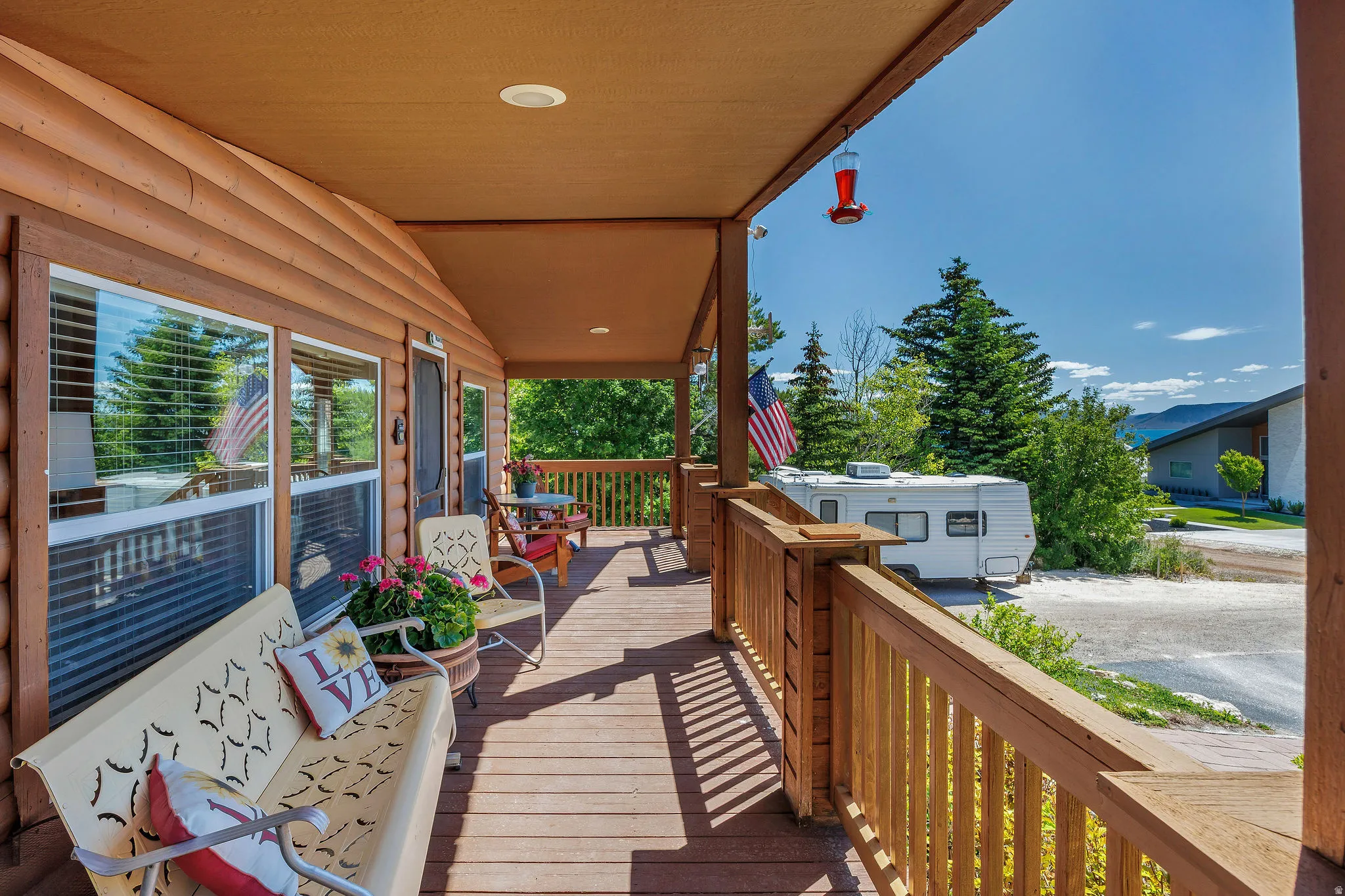 Covered wood-finish porch with a matching railing system