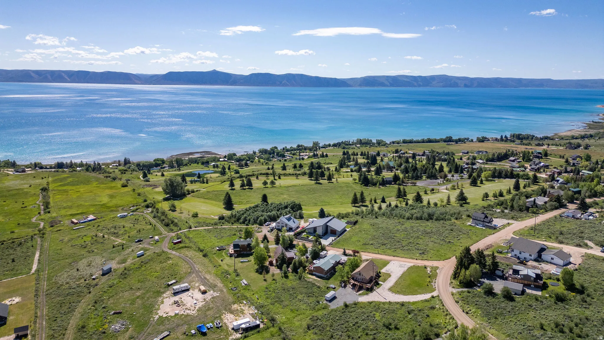 Aerial perspective showcasing a large body of water bordered by a mountainous landscape