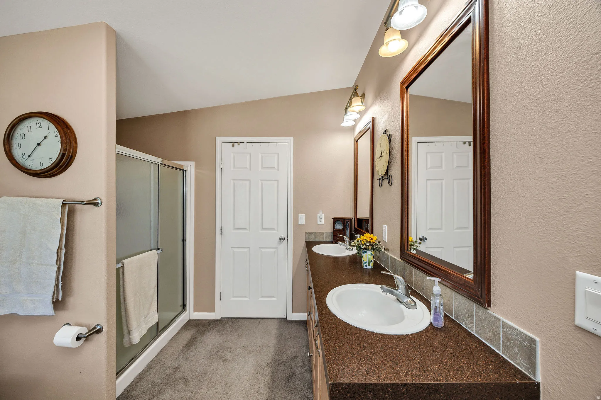 Dual sink vanity with brown-toned countertops and integrated white oval basins