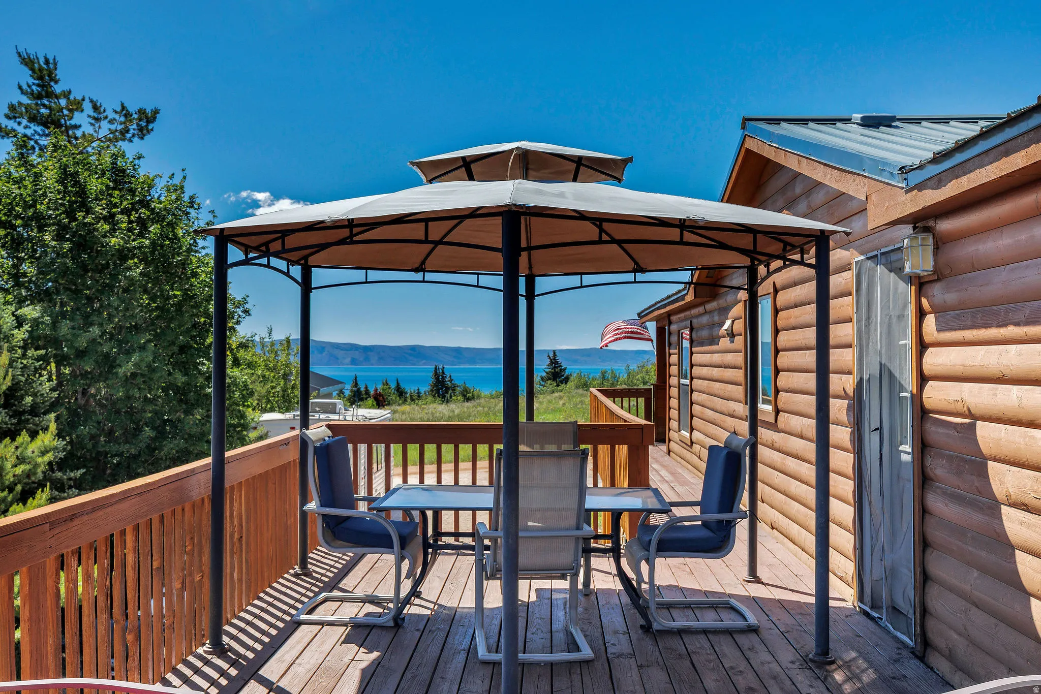 Expansive outdoor deck with wood-finish flooring and a gazebo structure