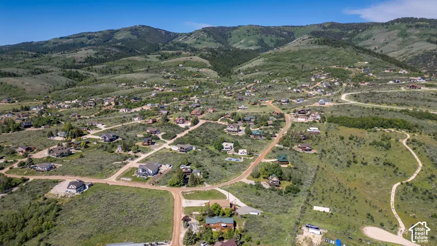 Expansive mountain landscape featuring numerous residential properties and winding roads