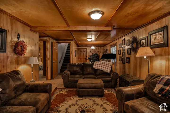 Finished lower level featuring extensive wood paneling, wood-finish ceiling, exposed wood beams, and recessed lighting