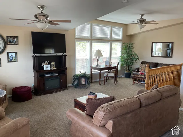 Expansive living area with neutral carpeting and warm-toned walls