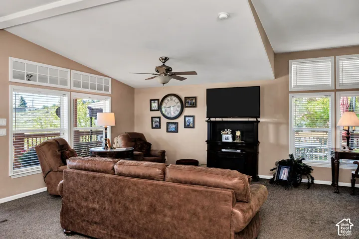Living area featuring vaulted ceilings, recessed lighting, and a ceiling fan