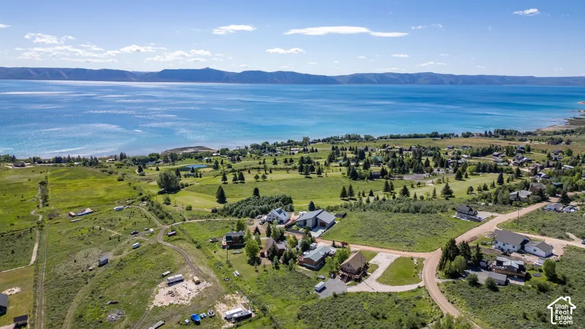 Aerial perspective showcasing a large body of water bordered by a mountainous landscape