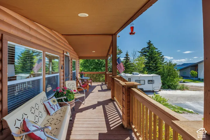 Covered wood-finish porch with a matching railing system