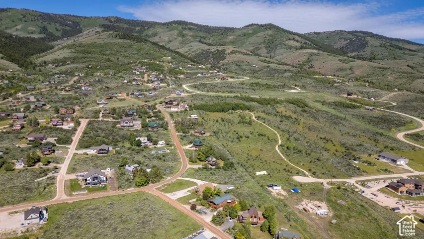 Expansive mountain landscape featuring varied terrain and multiple residential properties