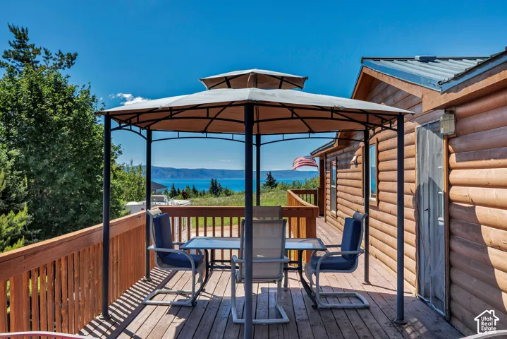 Expansive outdoor deck with wood-finish flooring and a gazebo structure