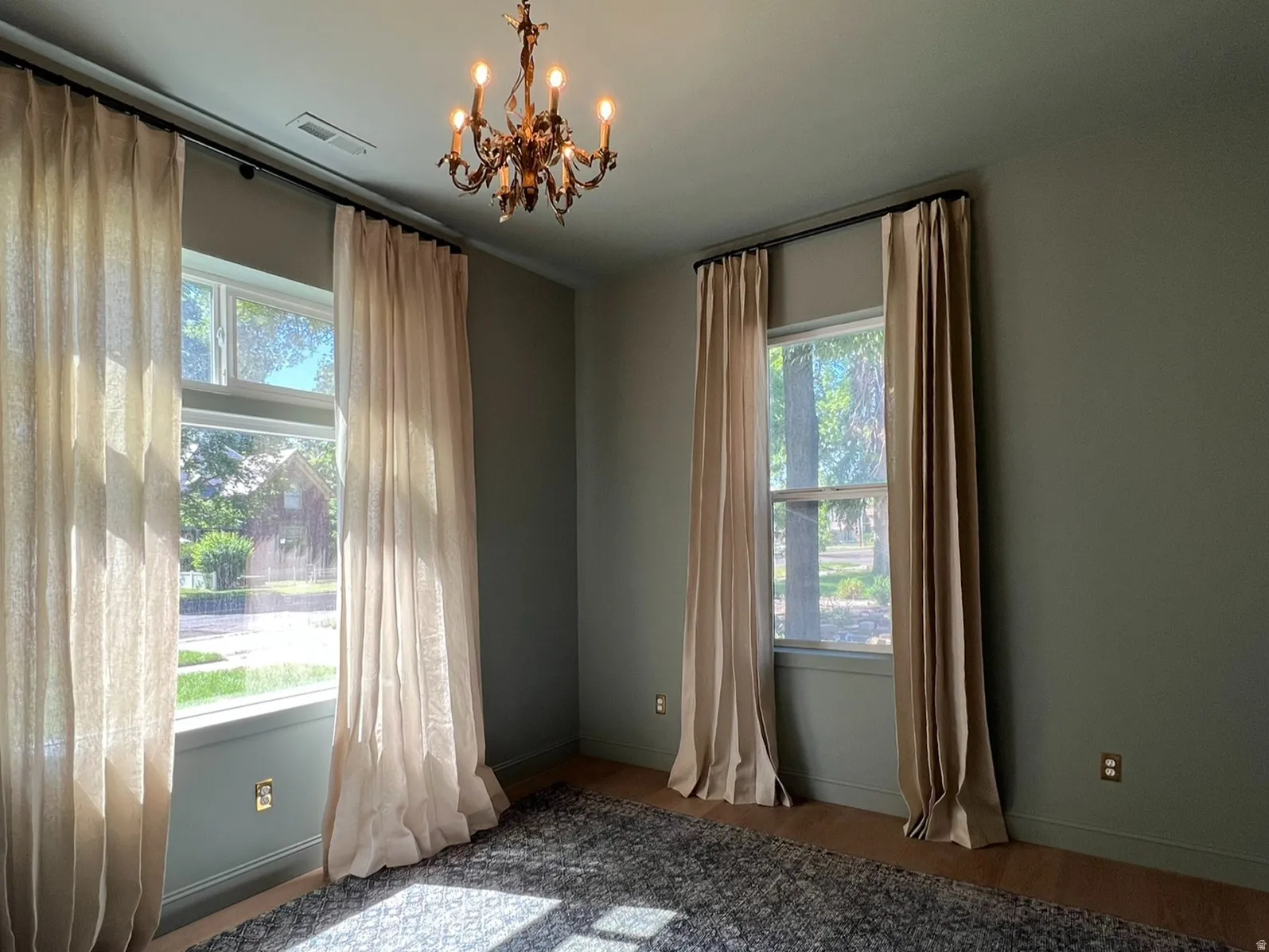 Room featuring a classic chandelier and multiple windows