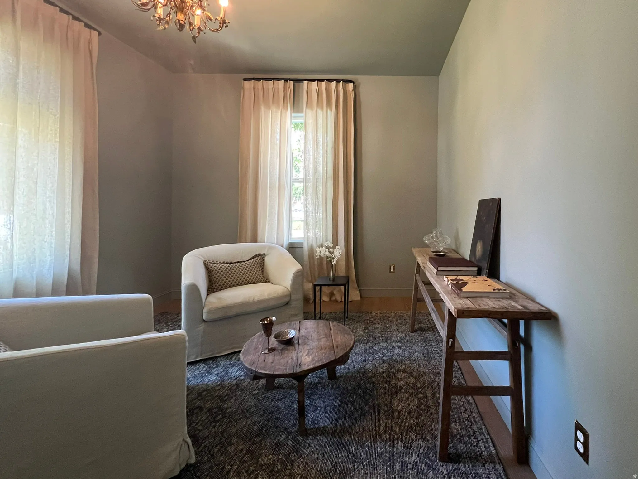 Room featuring light-toned walls, a dark ceiling, and light wood-finish flooring