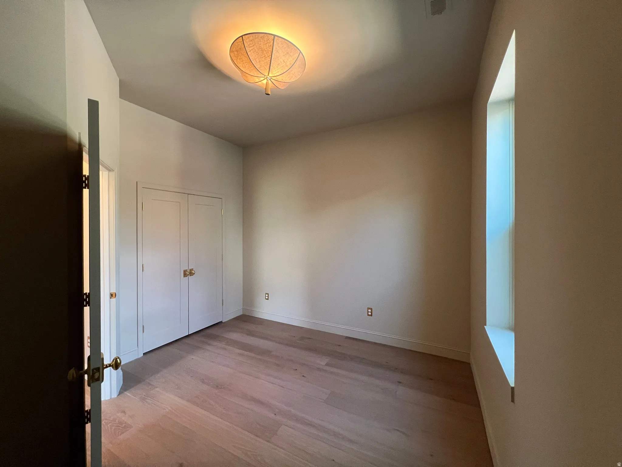 Light wood-finish flooring complements the neutral wall tones