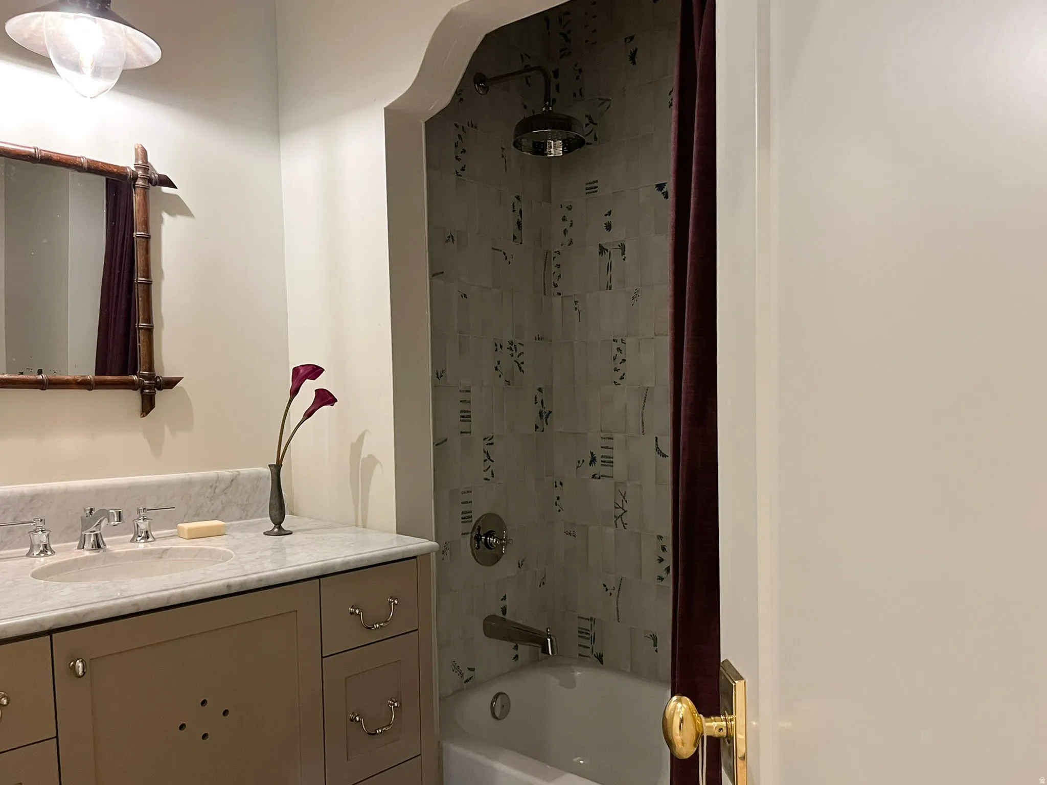 Bathroom vanity with an integrated oval sink, stone countertop, and polished chrome faucet