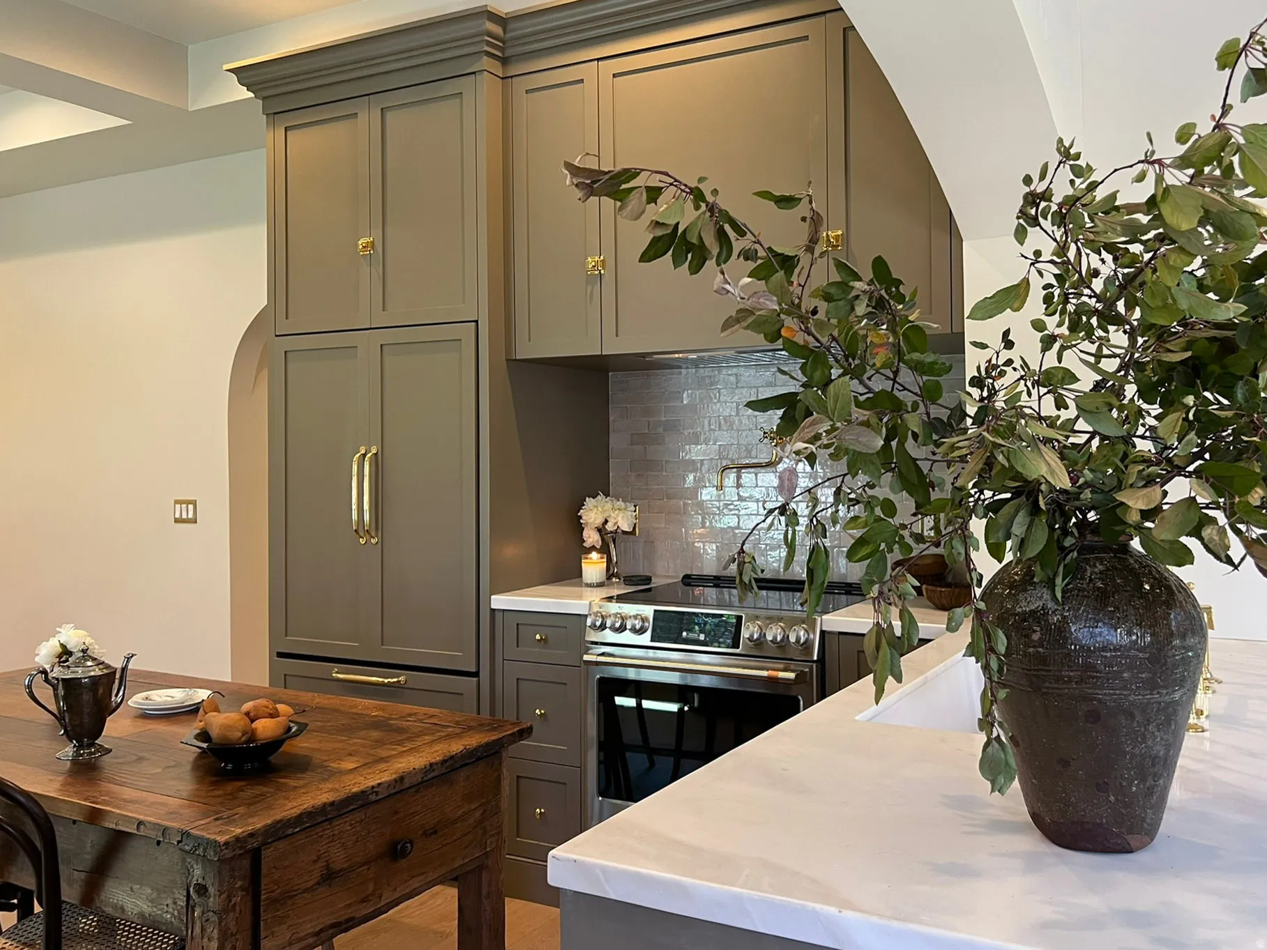 Kitchen featuring integrated paneled refrigeration, a stainless steel range, and a subway tile backsplash