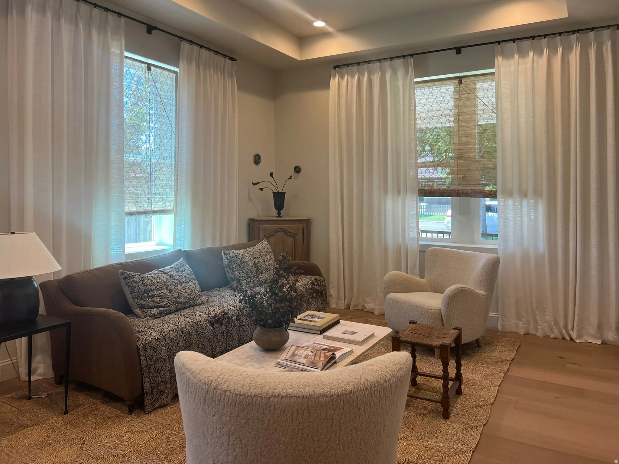 Living area featuring light wood-finish flooring and a tray ceiling