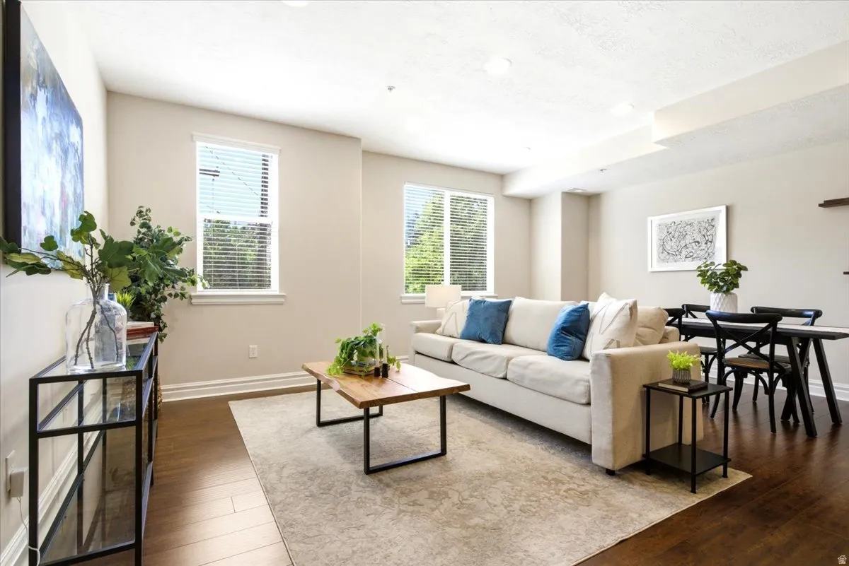 Open-concept living area with dark wood-finish flooring