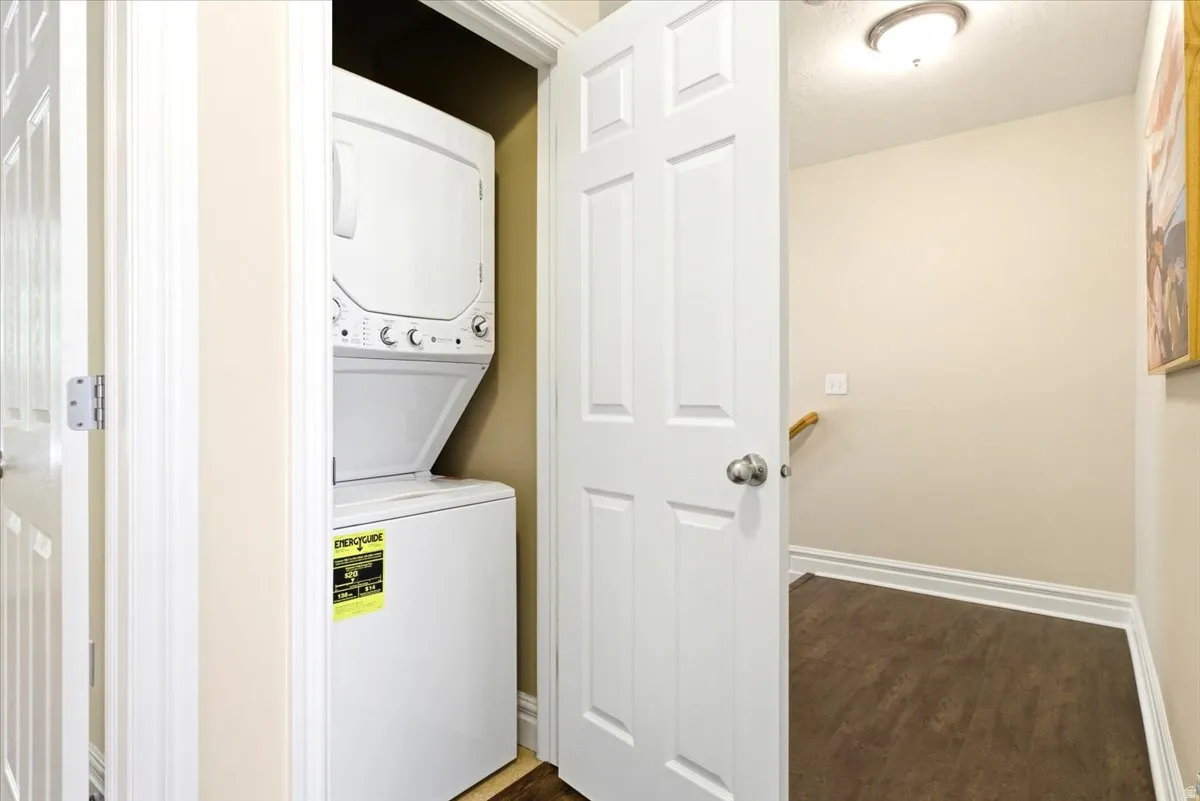 Dedicated laundry closet featuring a white stacked washer and dryer unit