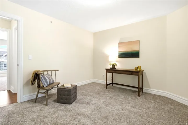 Carpeted room with neutral wall color and white trim