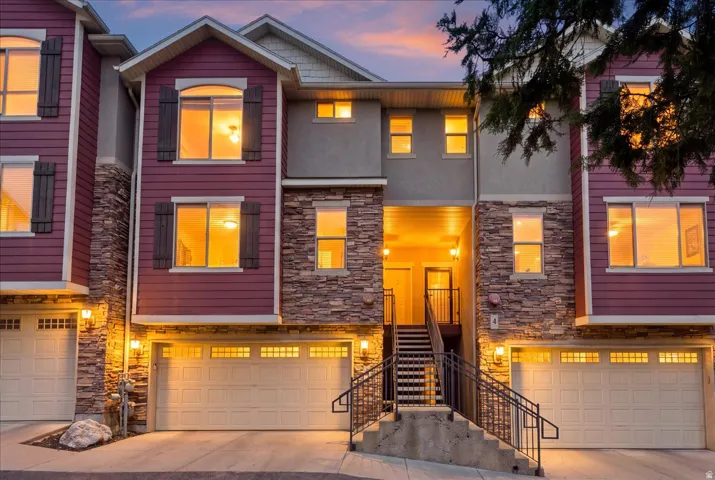Multi-level exterior featuring stone accents and siding