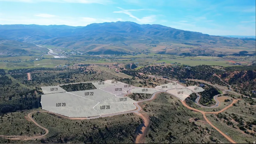 Aerial perspective showcasing multiple marked lots with mountain scenery in the background