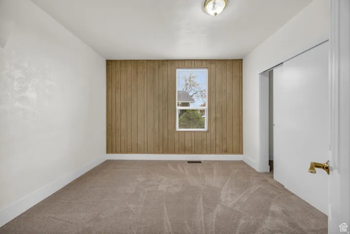 Interior space featuring light-colored carpeting and white baseboards