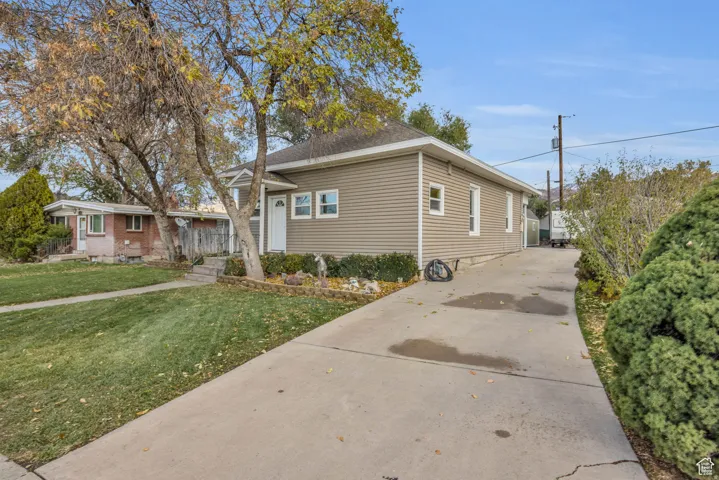 Exterior featuring horizontal siding, a gabled roofline, and a concrete driveway