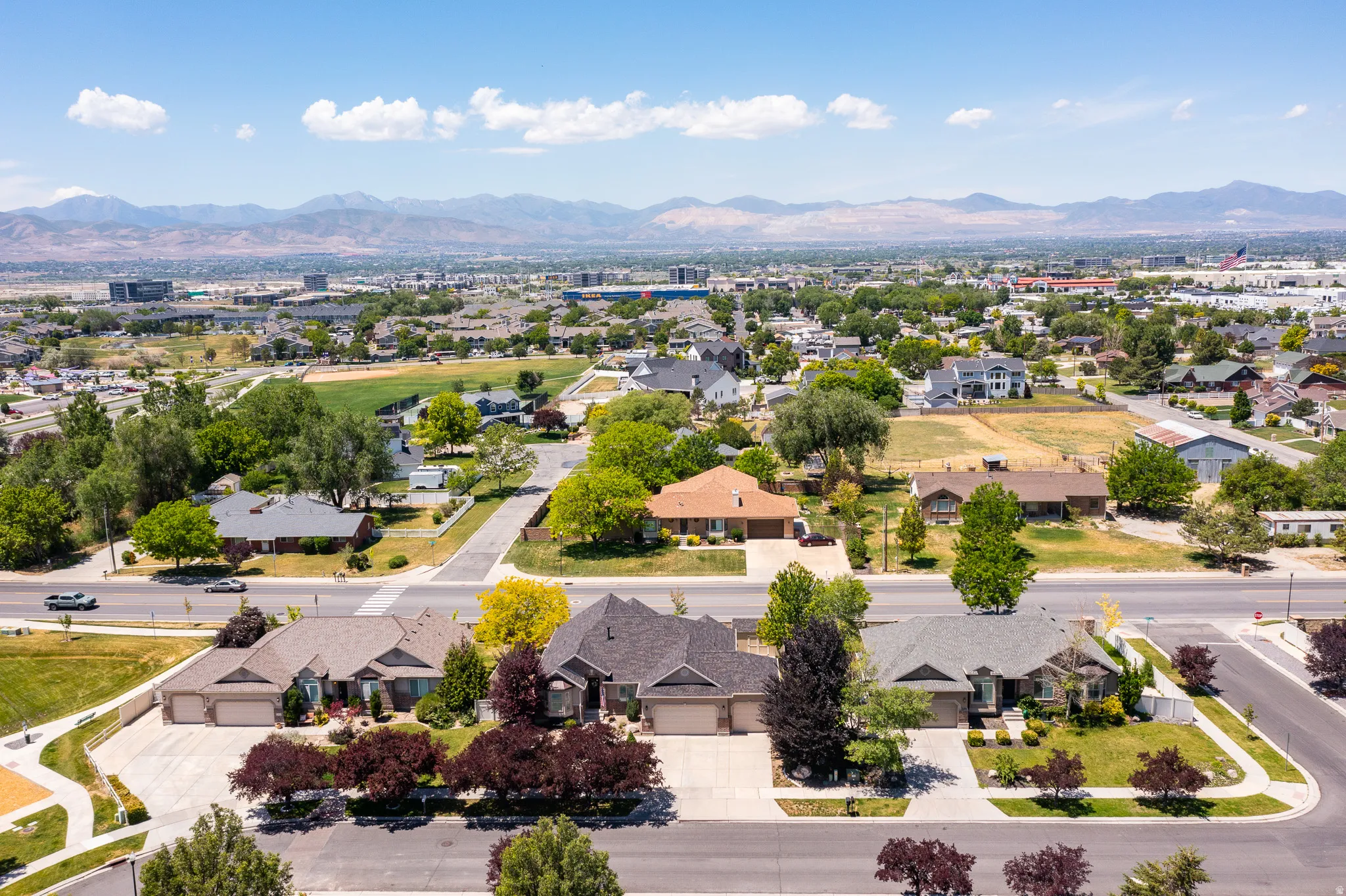Aerial perspective showcasing a residential neighborhood with distant mountains
