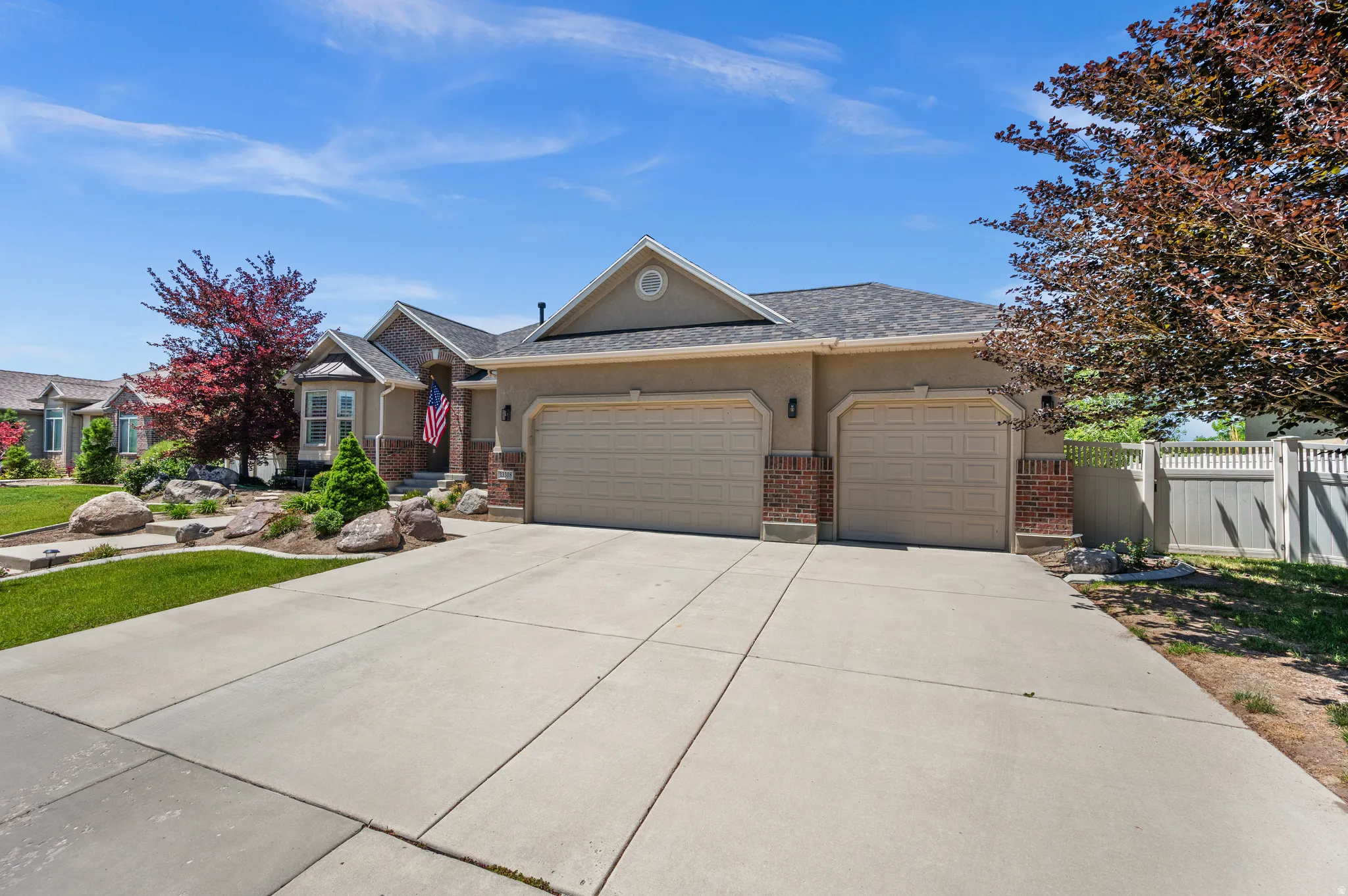 Concrete driveway leading to a two-car garage with panel doors