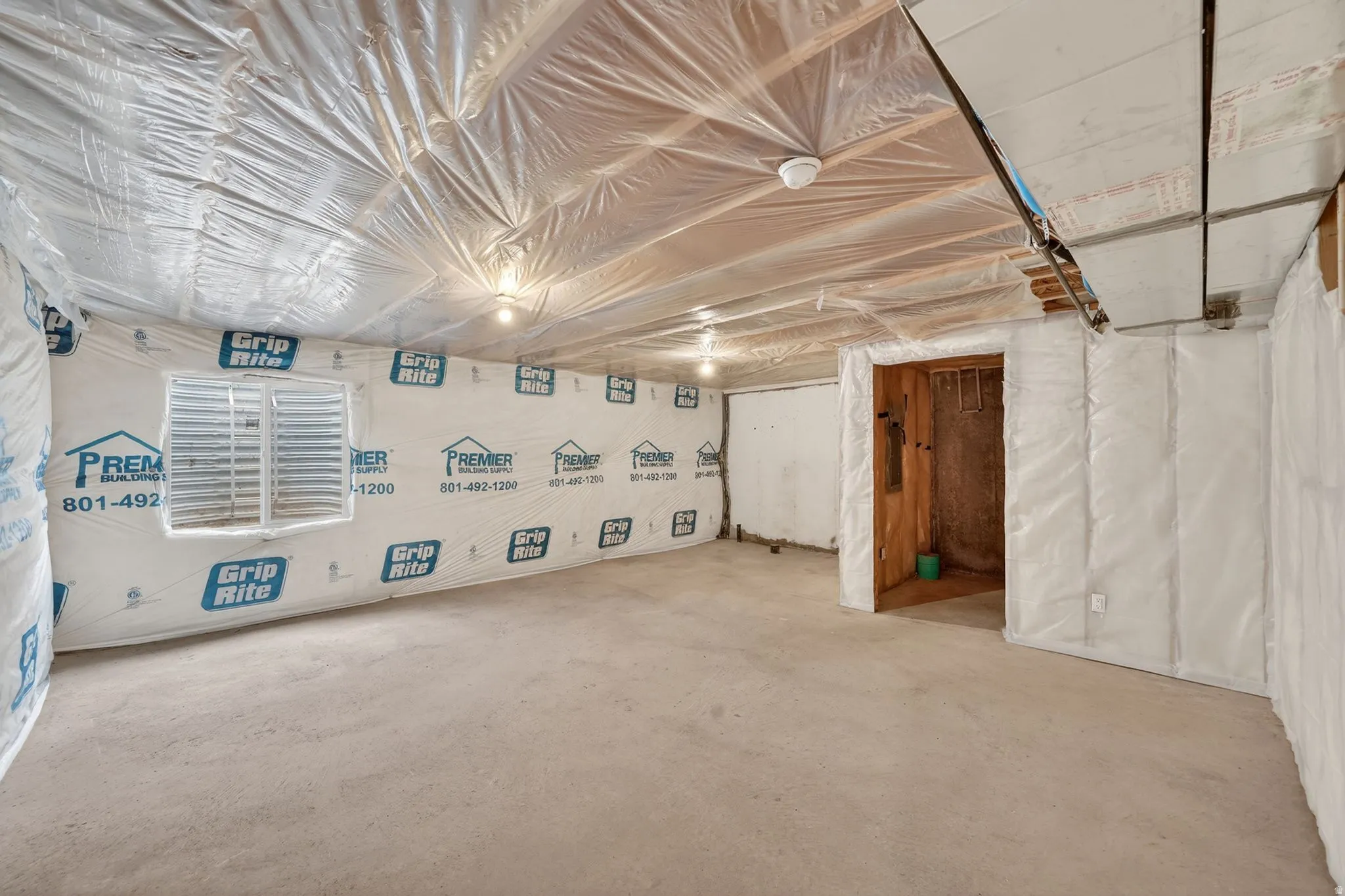Unfinished basement space with exposed concrete flooring