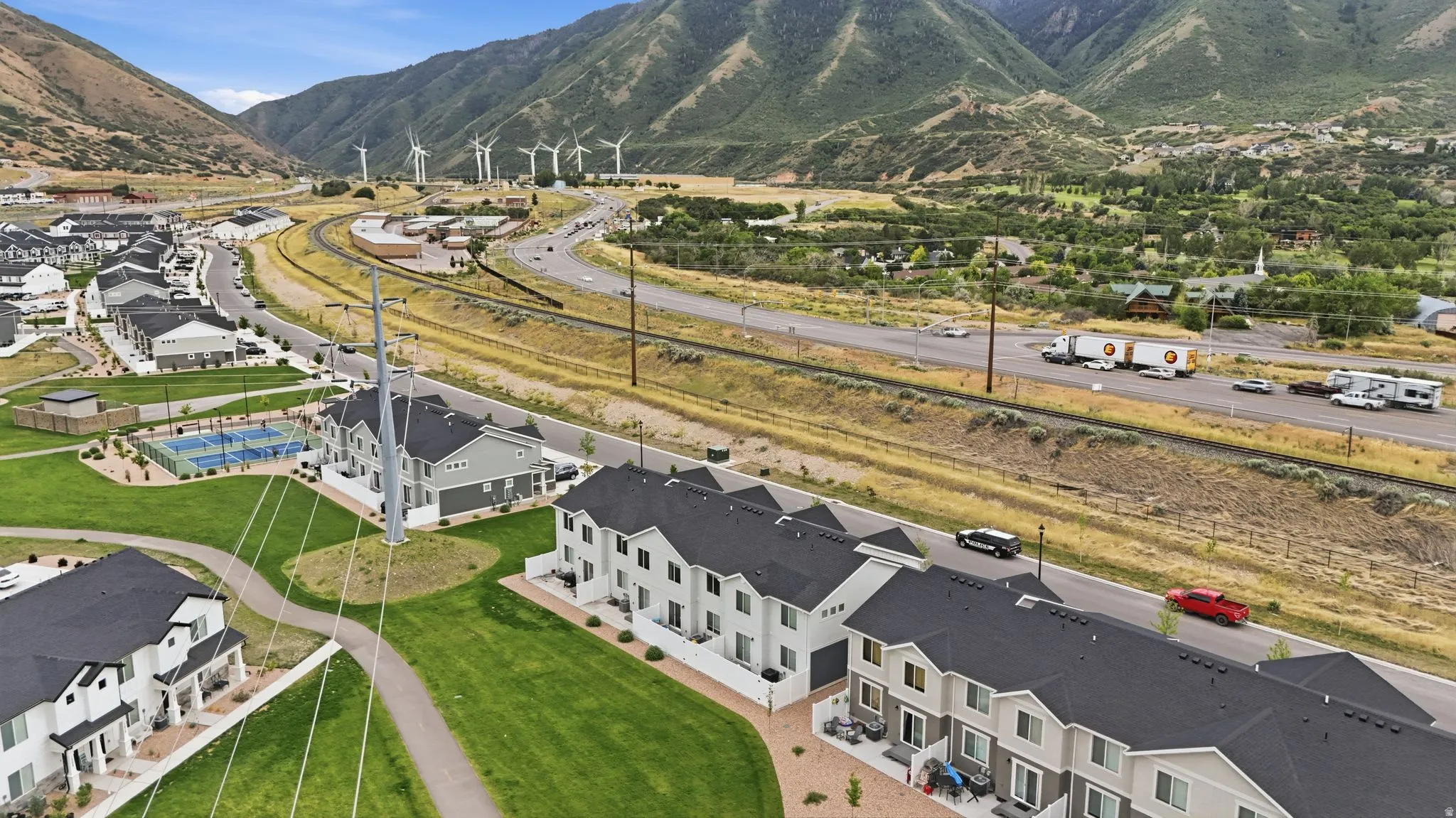 Modern townhomes featuring multi-level construction and dark grey roofing
