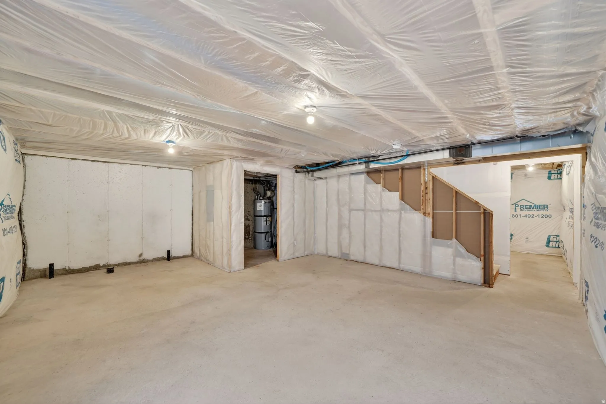 Unfinished basement with concrete flooring and exposed ceiling joists