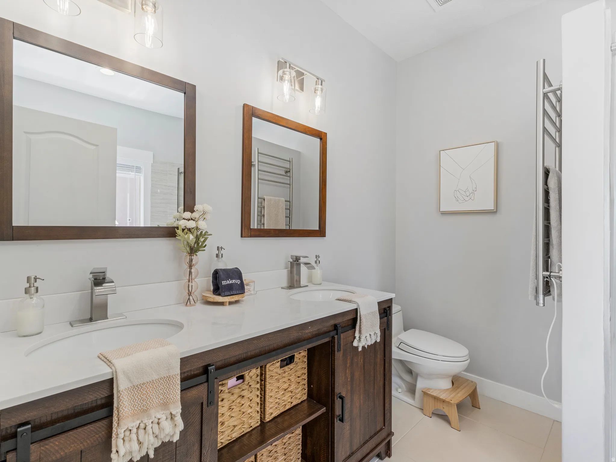 Double vanity with a white countertop and two undermount sinks