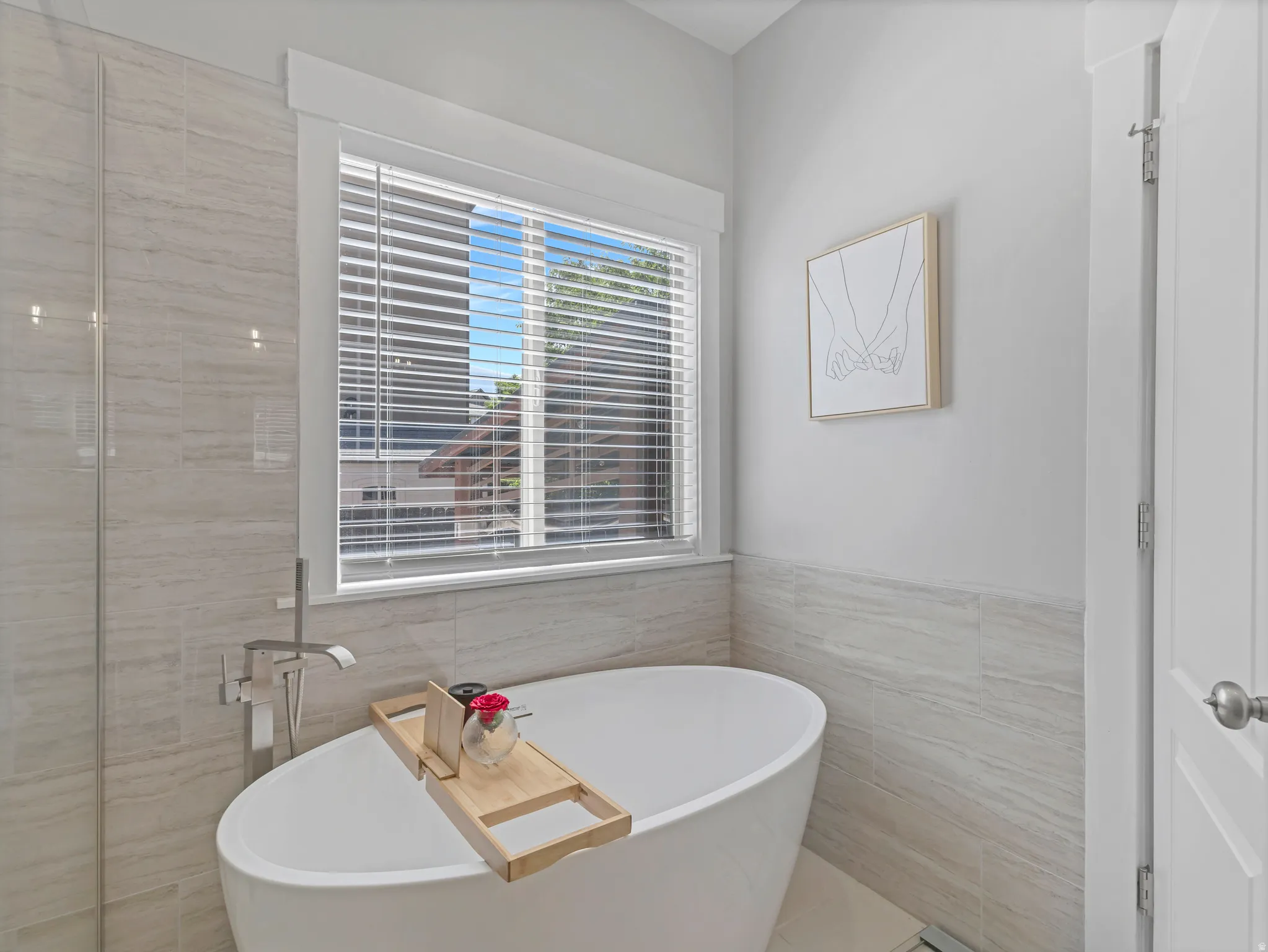 Freestanding soaking tub with floor-mounted chrome fixture