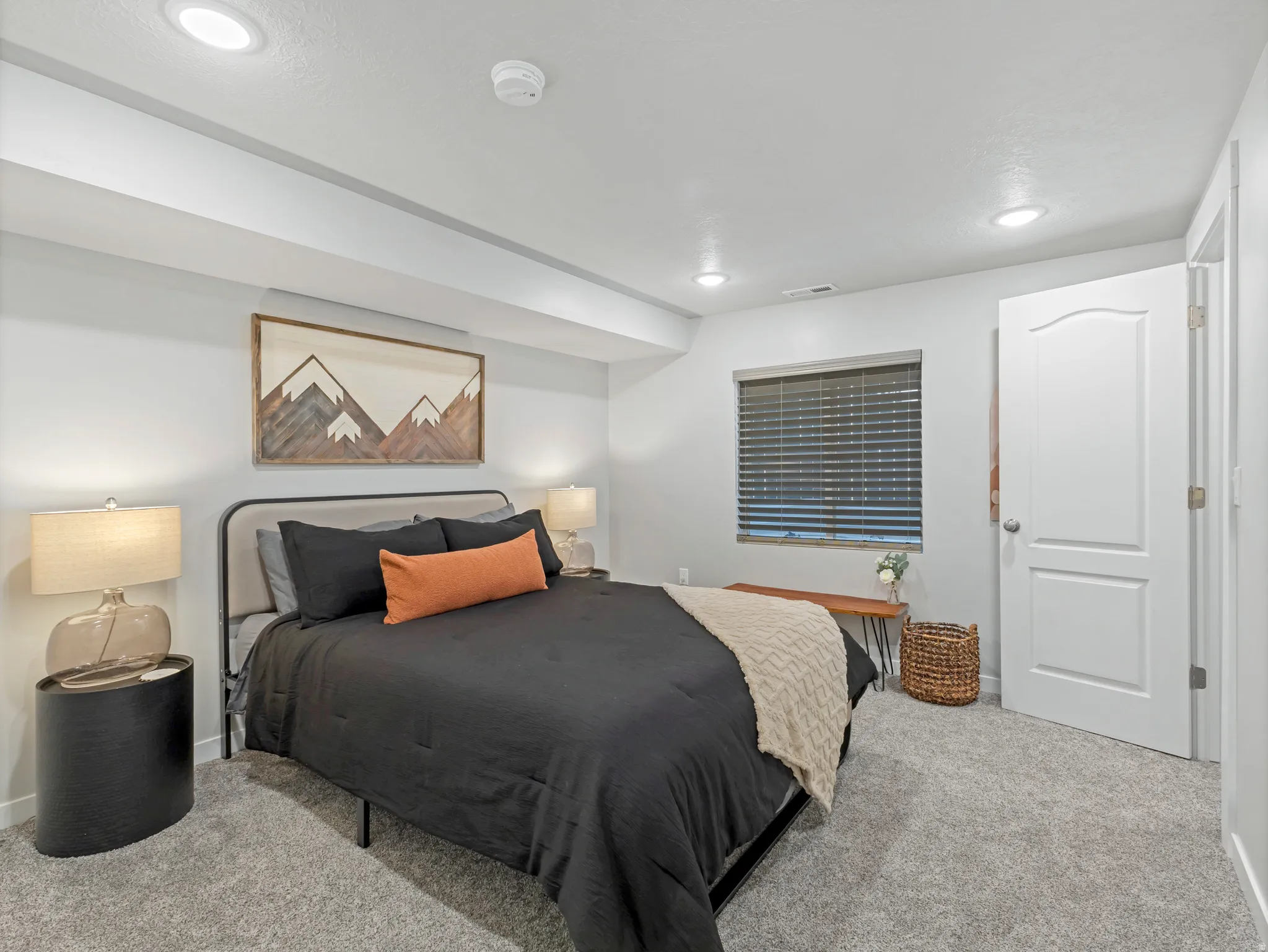 Carpeted bedroom featuring recessed lighting, a window with blinds, and a paneled door