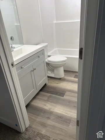 Light grey vanity with chrome hardware, white rectangular basin, and wall-mounted faucet
