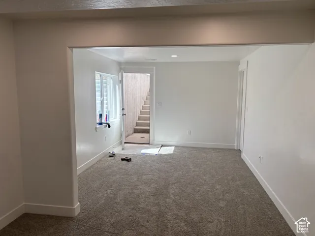 Recessed lighting, light gray carpeting, white walls, and white trim
