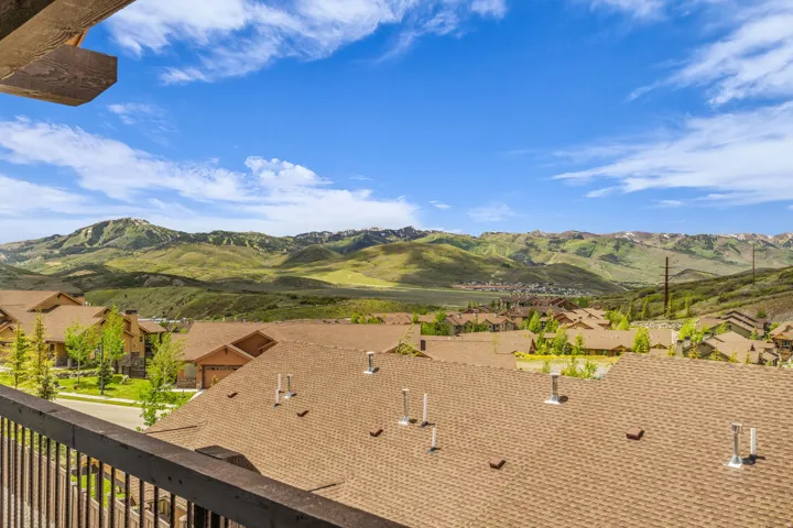 Expansive mountain scenery with a partial residential development